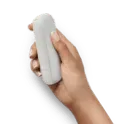 An IQOS device in a person's hand.