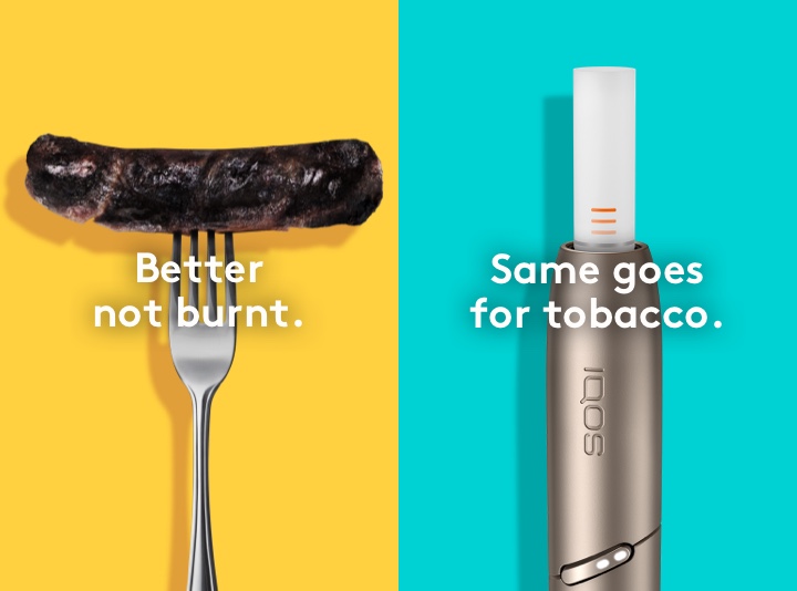 Burnt sausage on a fork compared to clean IQOS HEETS stick in IQOS 3 DUO holder