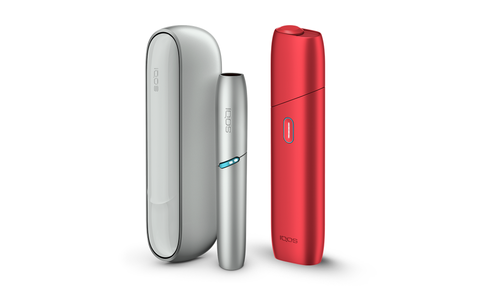 IQOS Originals heated tobacco products: IQOS Originals Duo holder and pocket charger in silver, next to IQOS Originals ONE device in red.